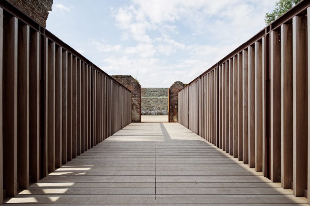 Elevated walkway and visitor centre added to 12th-century abbey ruins by Binario Architectes