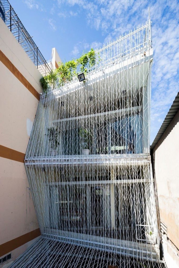 mel schenck envelops breeze house's façade with lattice screens in vietnam