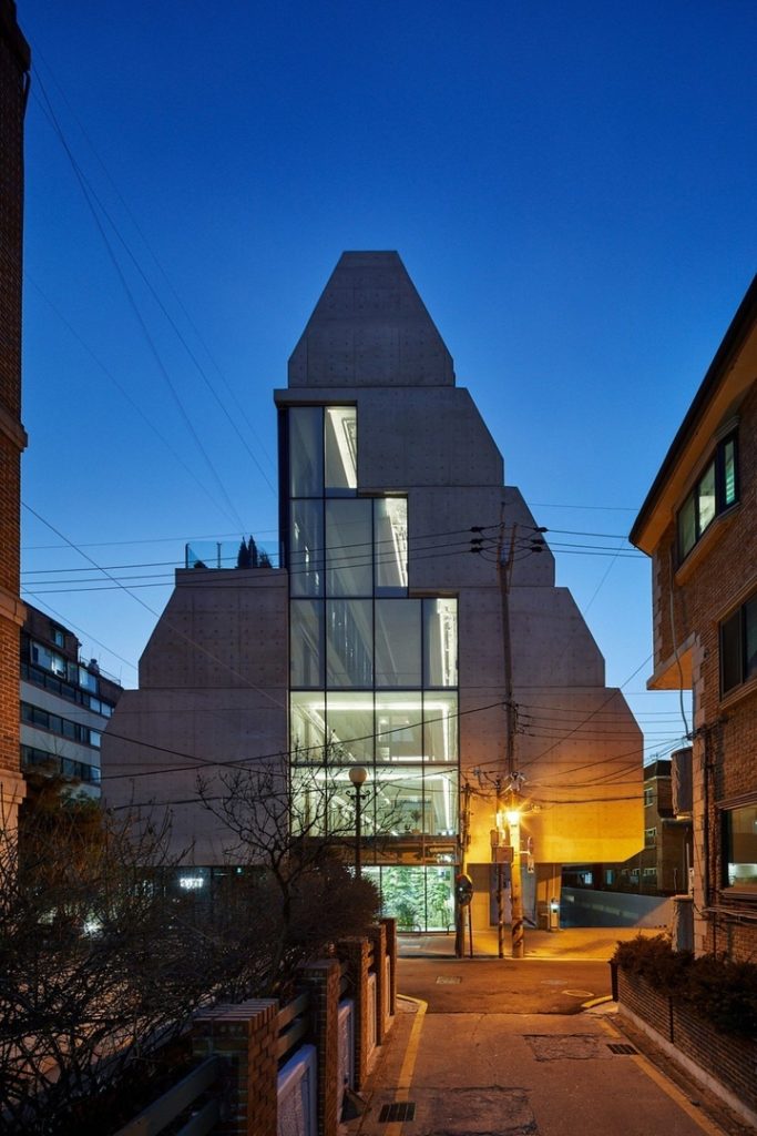 Treehouse is a sloping block of co-living apartments with a tree-filled atrium